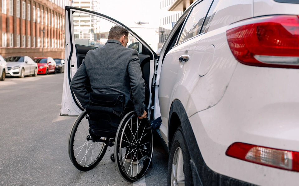 a wheel-chaired driver entering a self-driving car