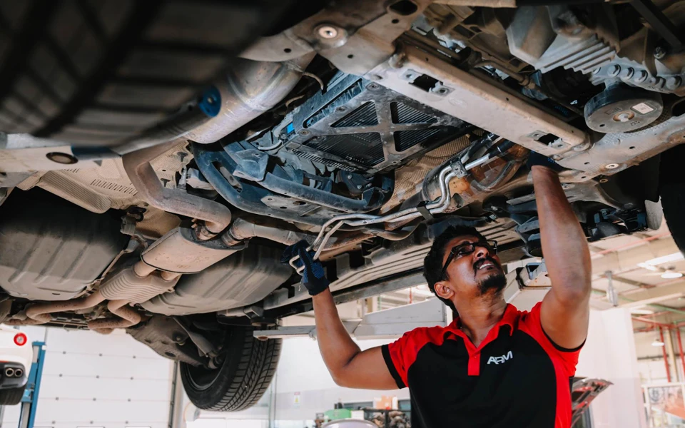 A mechanic carrying out car repair in a Dubai garage