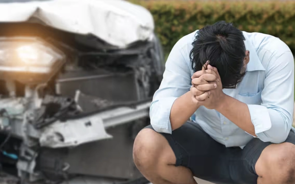 An image of a person after a car accident following up on filing a car insurance claim in the UAE