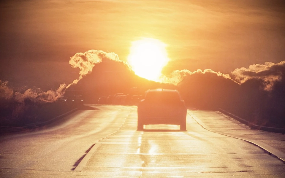 An image showing heat and extreme temperatures impacting car insurance—engine overheating, tire blowouts, higher claim risk.