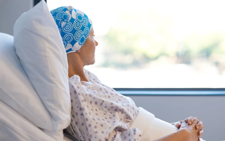 The image shows a cancer patient while explaining whether Dubai health insurance covers chronic illnesses.