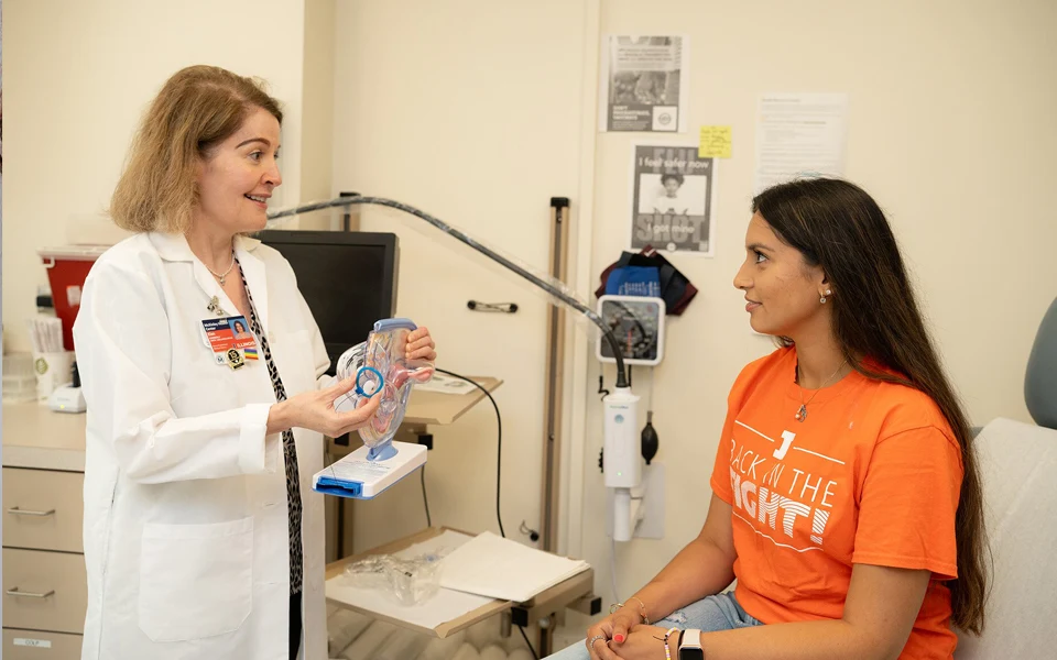 The image shows policy details and cost factors to consider when buying health insurance for women in the UAE.